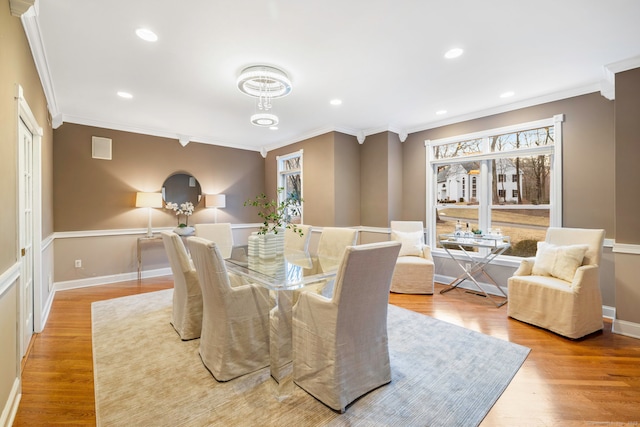 dining room featuring a wealth of natural light, recessed lighting, ornamental molding, and wood finished floors