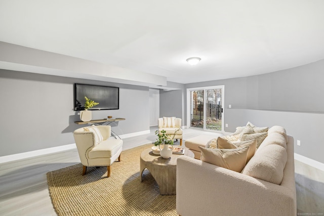 living room featuring baseboards and light wood-style flooring