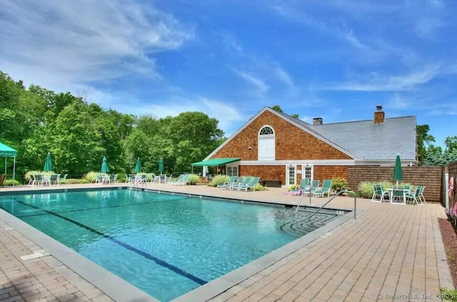 pool featuring a patio area and fence