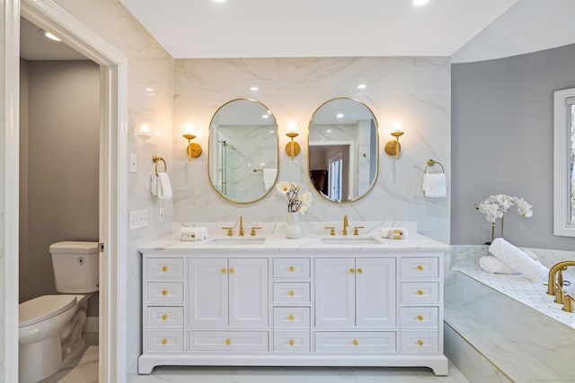 bathroom with a sink, toilet, recessed lighting, and double vanity