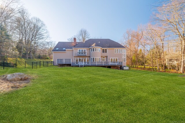 215 Paddock Hill Ln, Fairfield, CT 06824 - back of property with a deck and a chimney