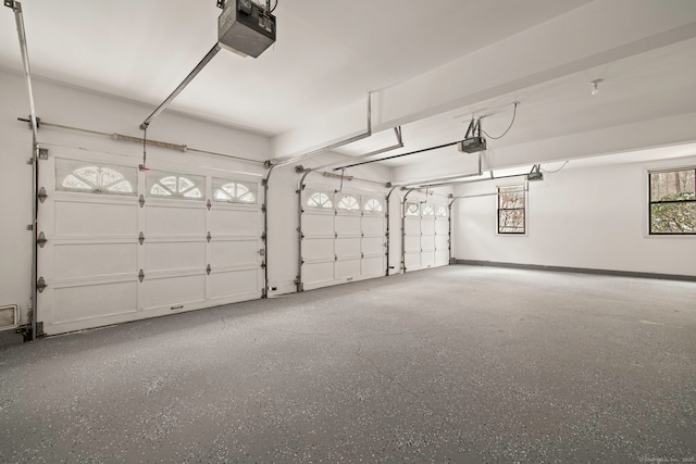 garage with baseboards and a garage door opener