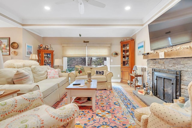 living room with wood finished floors, beamed ceiling, a fireplace, and ceiling fan