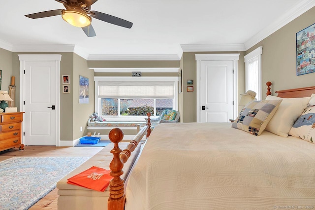 bedroom with crown molding, multiple windows, wood finished floors, and baseboards