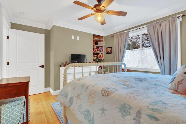 bedroom featuring ceiling fan, baseboards, light wood-style floors, and ornamental molding