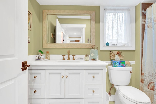 bathroom featuring toilet and vanity