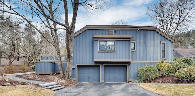 view of property exterior featuring a garage and driveway