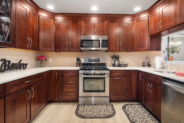 kitchen with recessed lighting, appliances with stainless steel finishes, light wood-style flooring, and light countertops