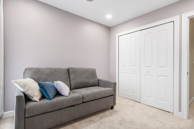 living area featuring recessed lighting, light colored carpet, and baseboards