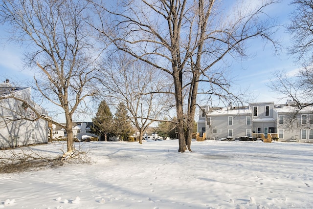 yard covered in snow with a residential view