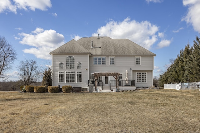 back of house with a pergola, a patio, fence, a yard, and roof with shingles