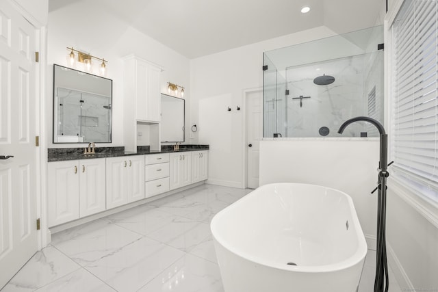 full bathroom featuring a marble finish shower, double vanity, a freestanding tub, a sink, and marble finish floor