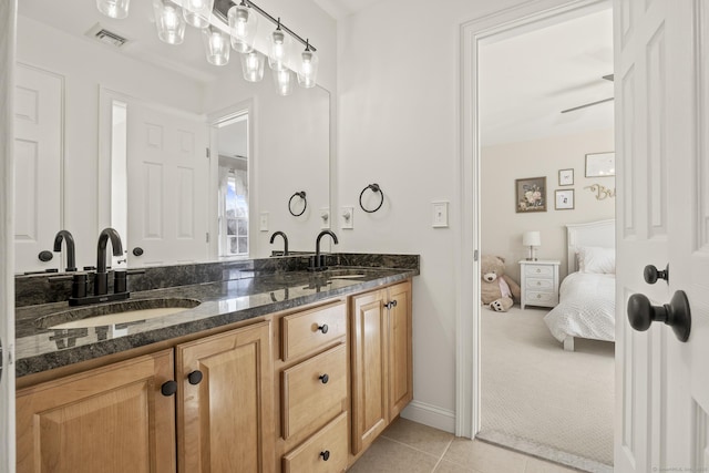 bathroom with tile patterned floors, double vanity, visible vents, and a sink