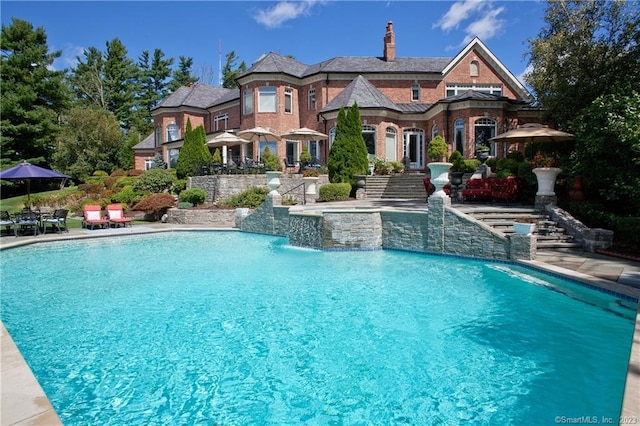 outdoor pool with a patio area