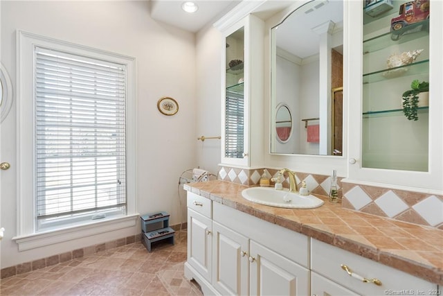 full bathroom with visible vents, backsplash, vanity, and tile patterned flooring