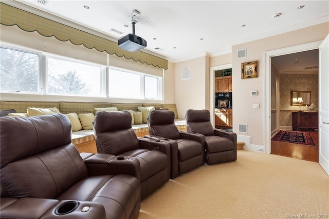 home theater room featuring visible vents, crown molding, and carpet floors