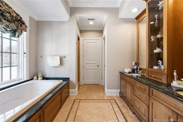 full bathroom featuring baseboards, a garden tub, double vanity, ornamental molding, and a sink