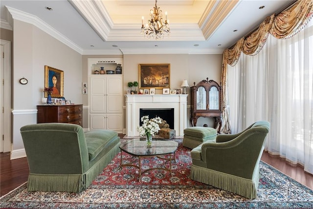 sitting room featuring a tray ceiling, wood finished floors, and a fireplace