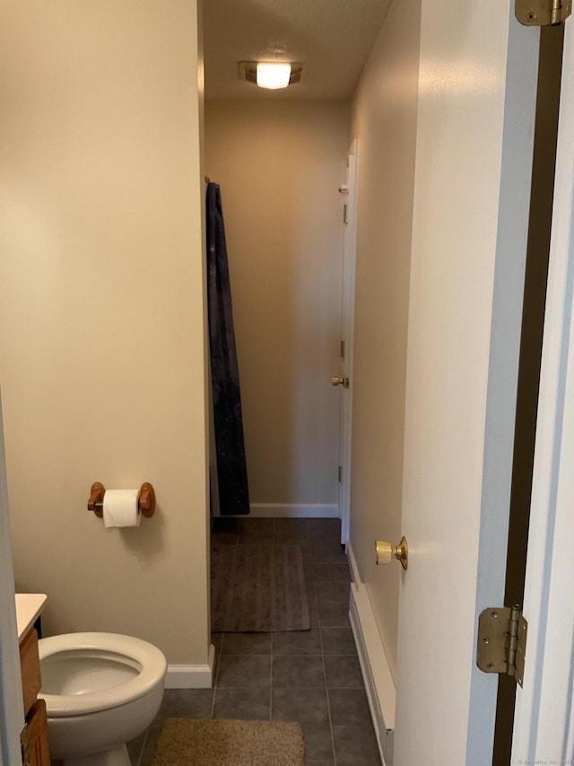 bathroom featuring vanity, tile patterned floors, toilet, and baseboards