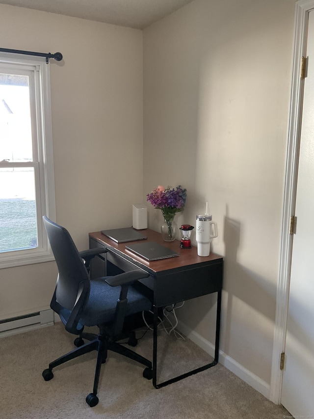 office area with a baseboard heating unit, carpet floors, and baseboards