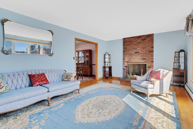 living room with a fireplace and wood finished floors