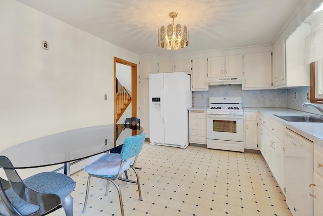 kitchen with white appliances, light floors, a sink, under cabinet range hood, and a notable chandelier