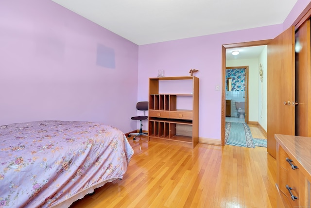 bedroom featuring light wood-style floors and baseboards