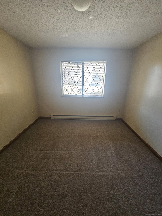 carpeted spare room featuring a textured ceiling, baseboards, and a baseboard radiator