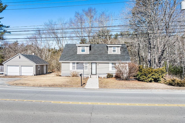 view of front of house featuring a garage, a shingled roof, and an outdoor structure