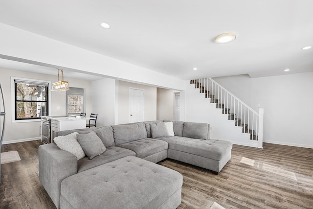 living room with recessed lighting, stairway, baseboards, and dark wood-style floors