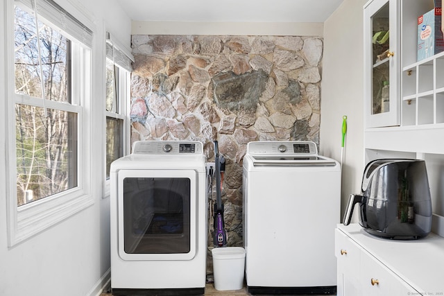 laundry area featuring cabinet space and washing machine and clothes dryer