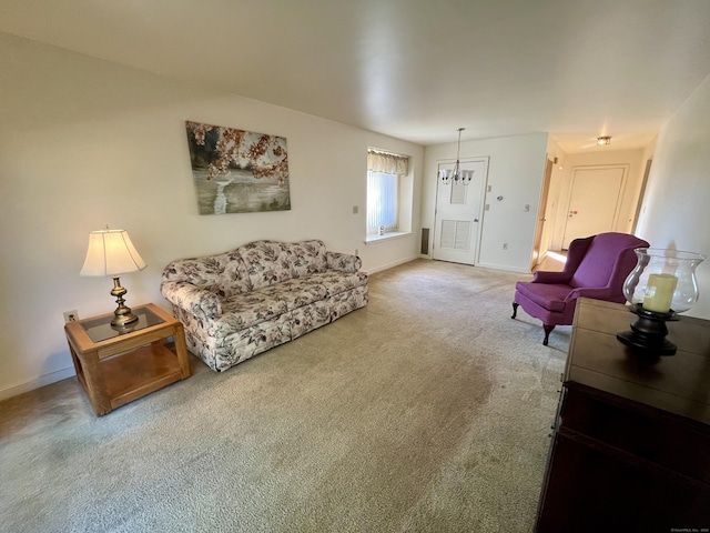 living room featuring a notable chandelier, baseboards, and carpet floors