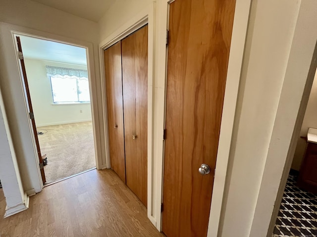 corridor with light wood-type flooring