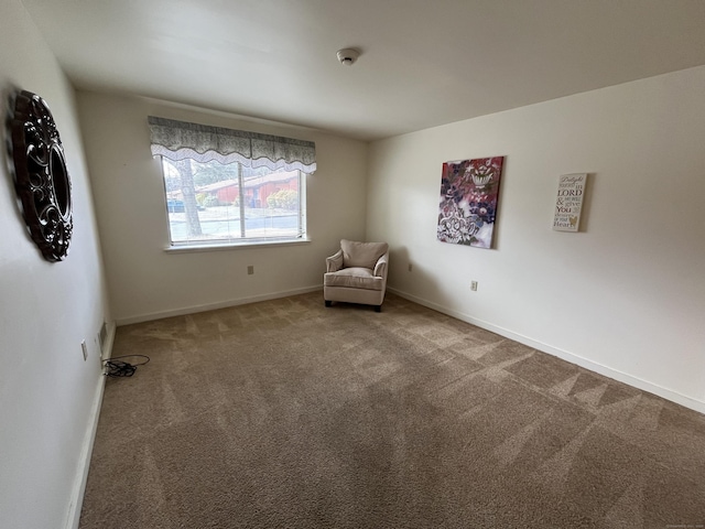 unfurnished room with carpet flooring and baseboards