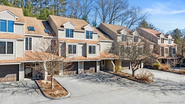 view of property with an attached garage and driveway