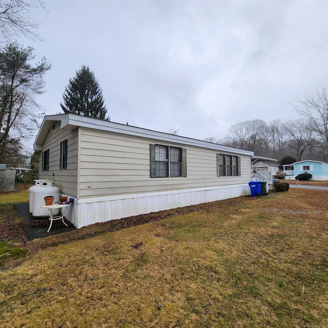 view of side of property featuring a yard