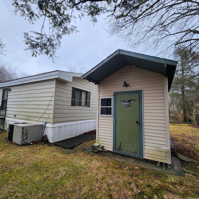 view of outbuilding featuring central AC unit and an outdoor structure