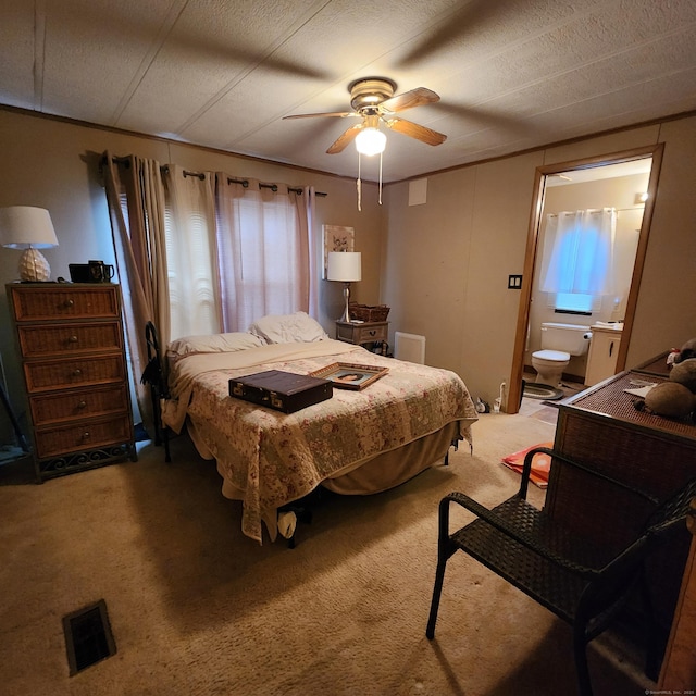 bedroom featuring visible vents, light colored carpet, ceiling fan, and multiple windows