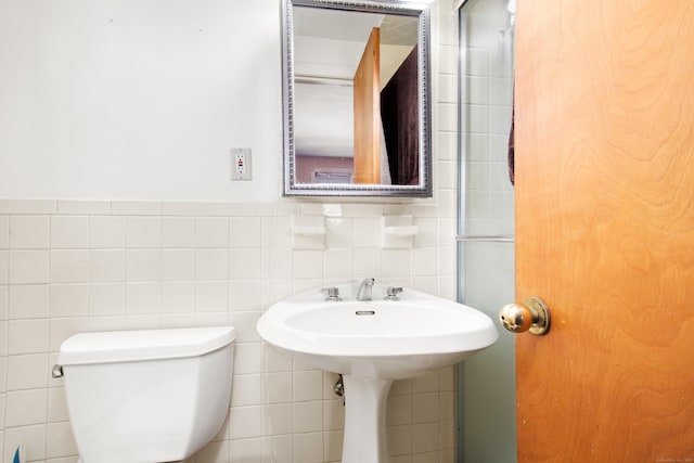 bathroom with toilet and tile walls