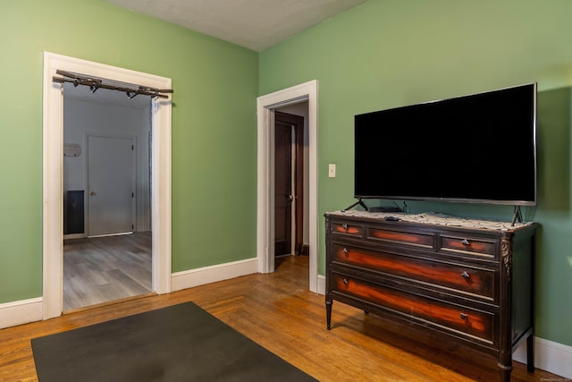 interior space featuring baseboards and wood finished floors