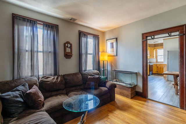 living area with visible vents and light wood-style flooring