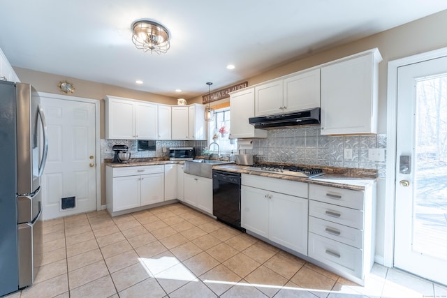 kitchen with white cabinets, backsplash, under cabinet range hood, and stainless steel appliances