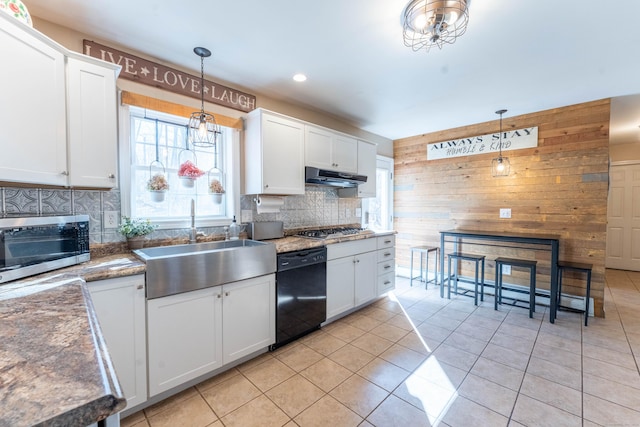 kitchen featuring stainless steel gas cooktop, under cabinet range hood, black dishwasher, decorative backsplash, and a sink