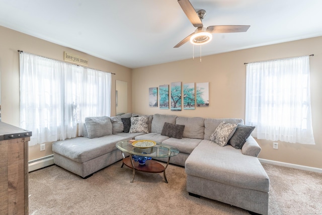 carpeted living room featuring a wealth of natural light, a ceiling fan, baseboards, and a baseboard radiator