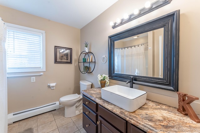 bathroom with tile patterned floors, toilet, vanity, and a baseboard radiator