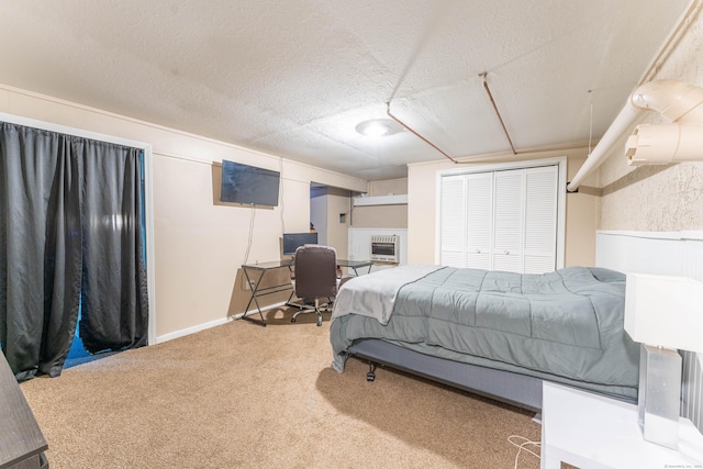 bedroom featuring carpet flooring, a closet, and a textured ceiling