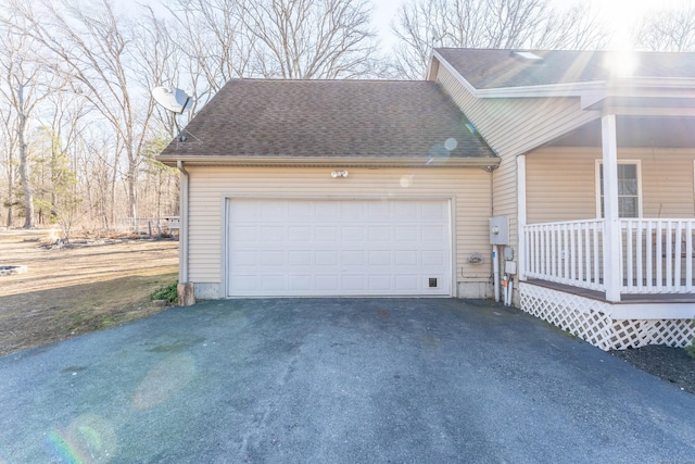 garage with covered porch and driveway