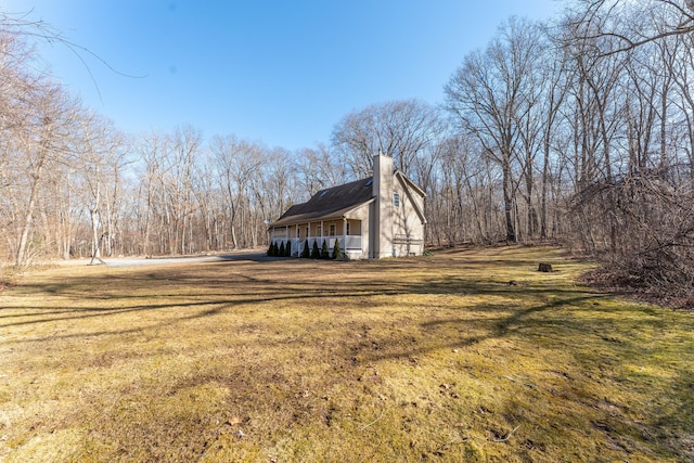 view of property exterior with a yard and a chimney