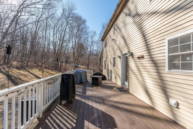 wooden deck featuring a grill