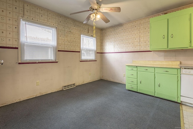 kitchen featuring visible vents, green cabinets, white dishwasher, and wallpapered walls